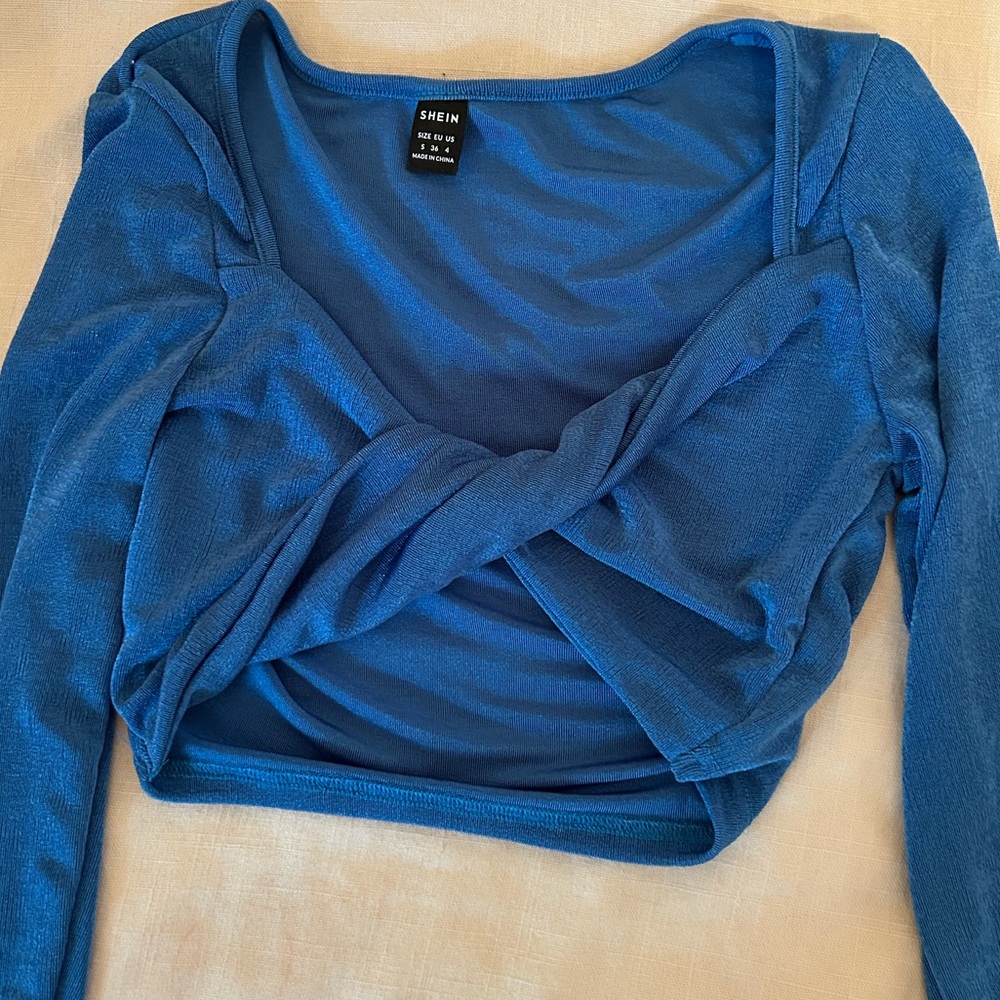 Cropped blue cross front going out top